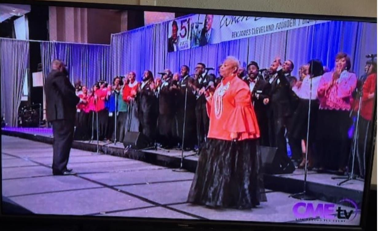 Dallas Chapter choir in red leading worship